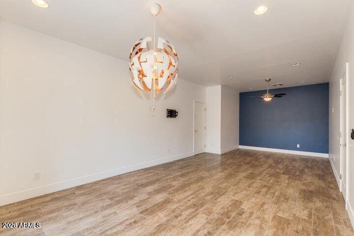 3814 North 9th Street Phoenix, AZ 85014 - Photo 17 of 18 an empty room with wooden floor and windows