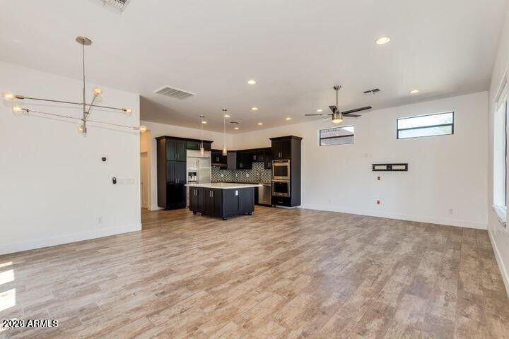 3814 North 9th Street Phoenix, AZ 85014 - Photo 3 of 18 a view of a kitchen with a sink and a refrigerator