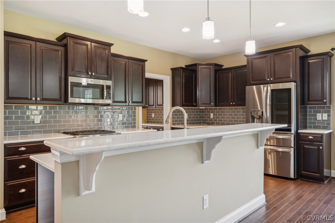 7004 Benhall Circle Glen Allen, VA 23059 - Photo 16 of 50 a kitchen with stainless steel appliances granite countertop a sink stove and refrigerator
