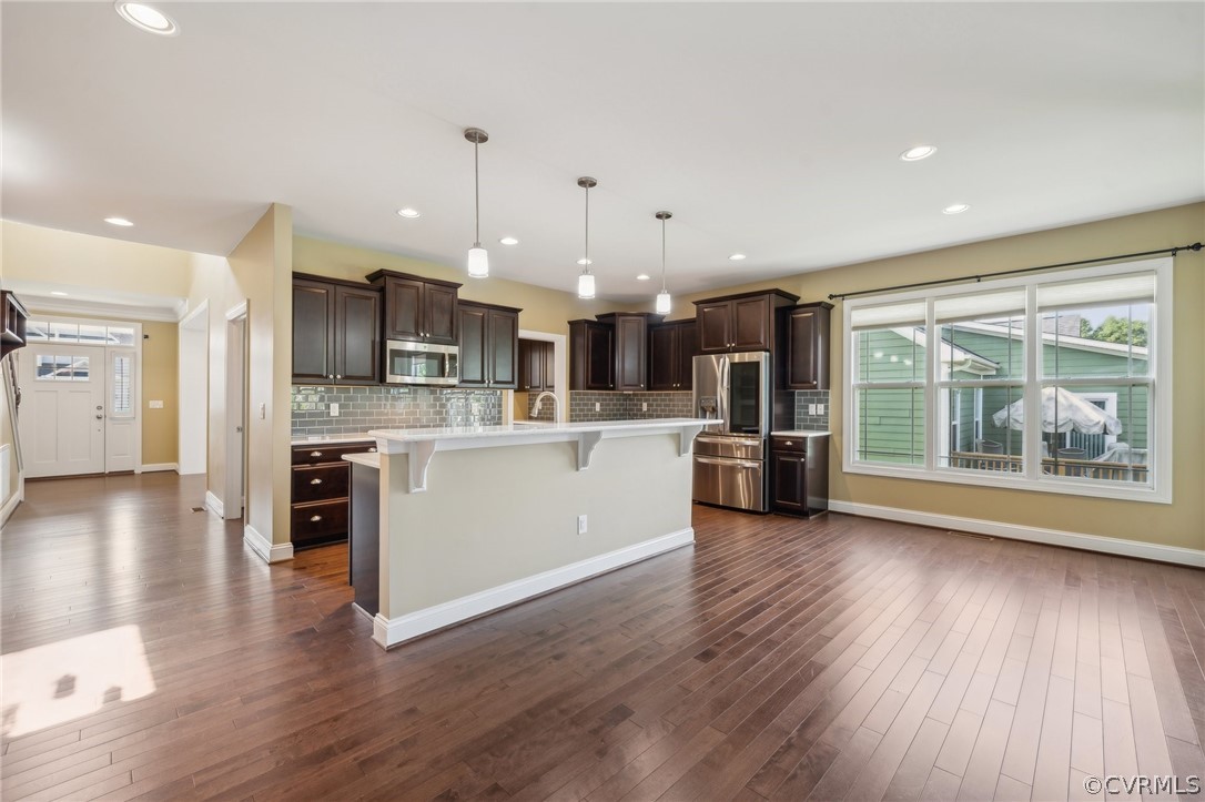 7004 Benhall Circle Glen Allen, VA 23059 - Photo 17 of 50 a kitchen with stainless steel appliances kitchen island wooden floors and white cabinets