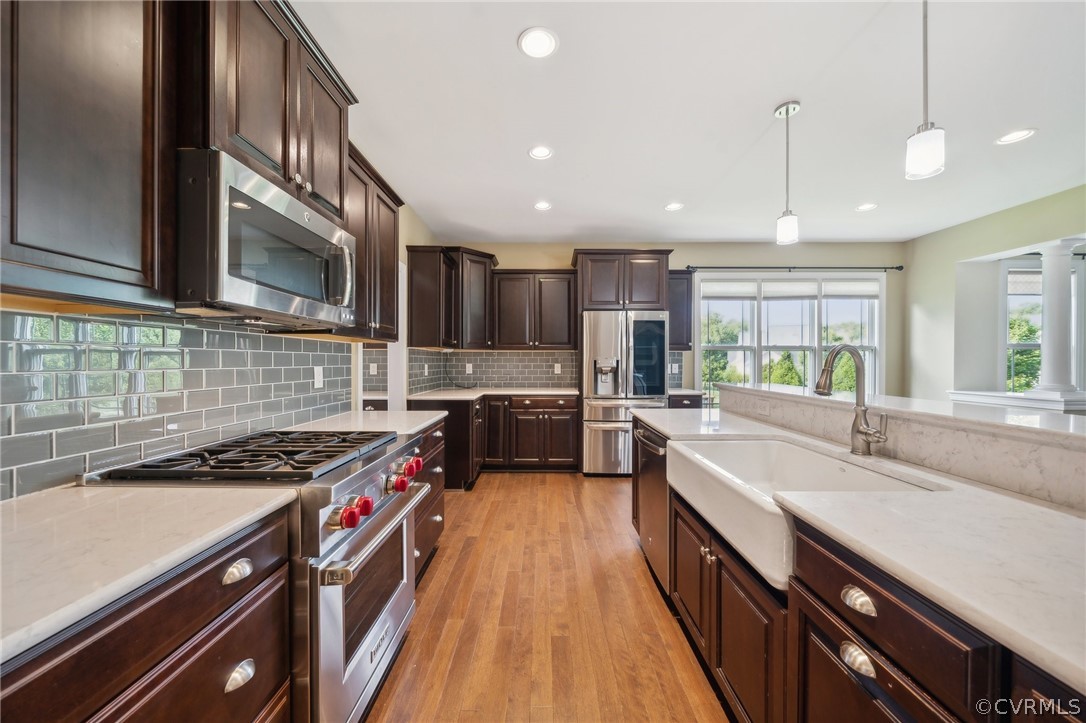 7004 Benhall Circle Glen Allen, VA 23059 - Photo 21 of 50 a kitchen with stainless steel appliances a sink a stove top oven a counter space and cabinets