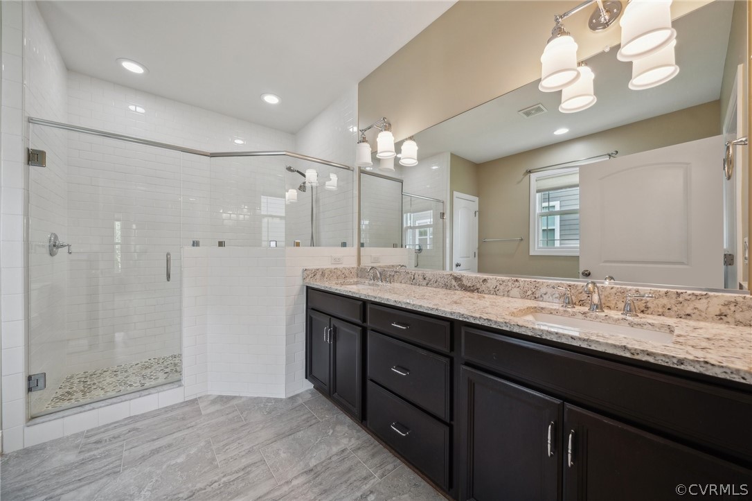 7004 Benhall Circle Glen Allen, VA 23059 - Photo 33 of 50 a bathroom with a granite countertop sink a large mirror and shower