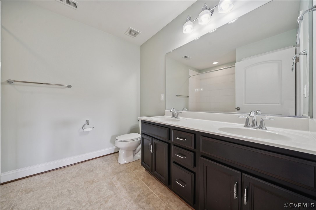 7004 Benhall Circle Glen Allen, VA 23059 - Photo 38 of 50 a bathroom with a double vanity sink and a mirror