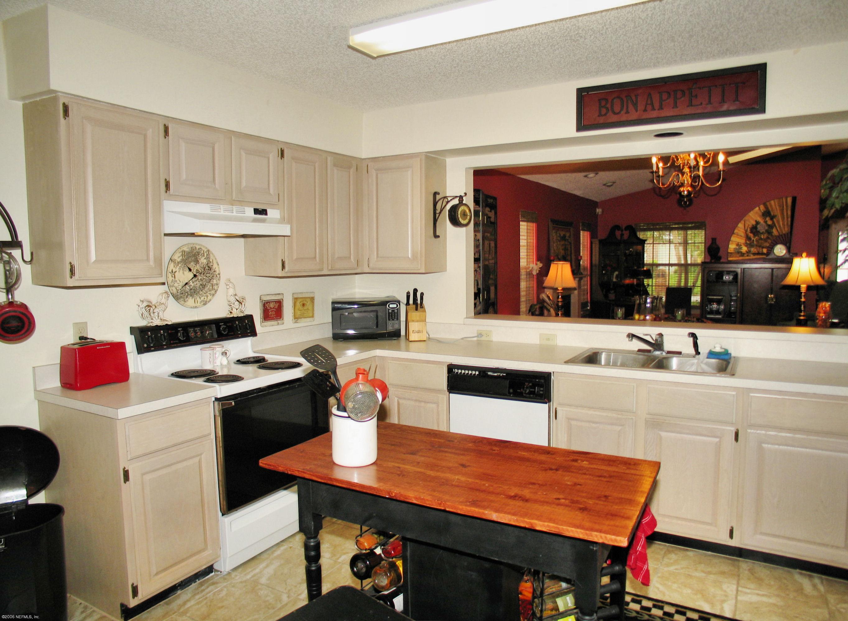 5434 Spring Brook Road Jacksonville, FL 32277 - Photo 3 of 4 a kitchen with a stove and cabinets
