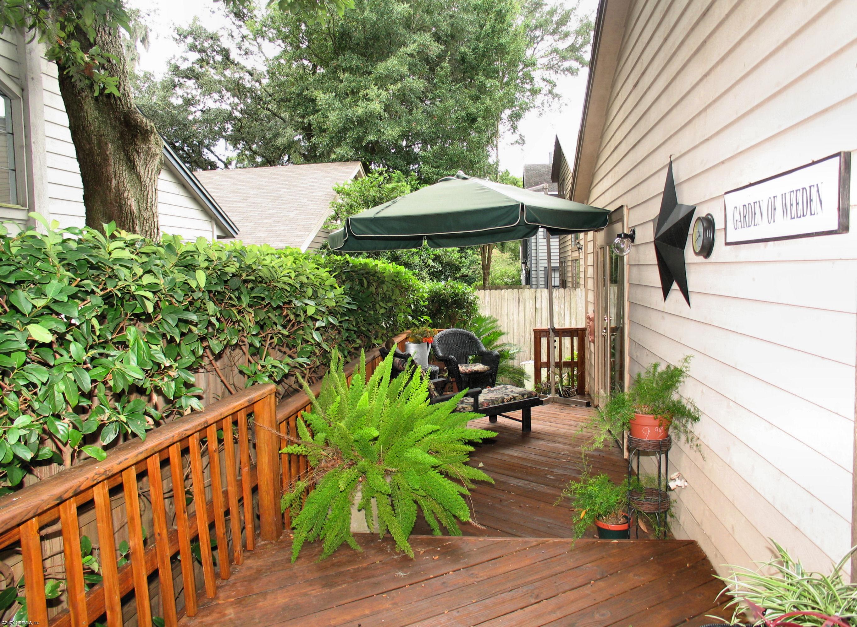 5434 Spring Brook Road Jacksonville, FL 32277 - Photo 4 of 4 a backyard of a house with wooden floor yard and outdoor seating