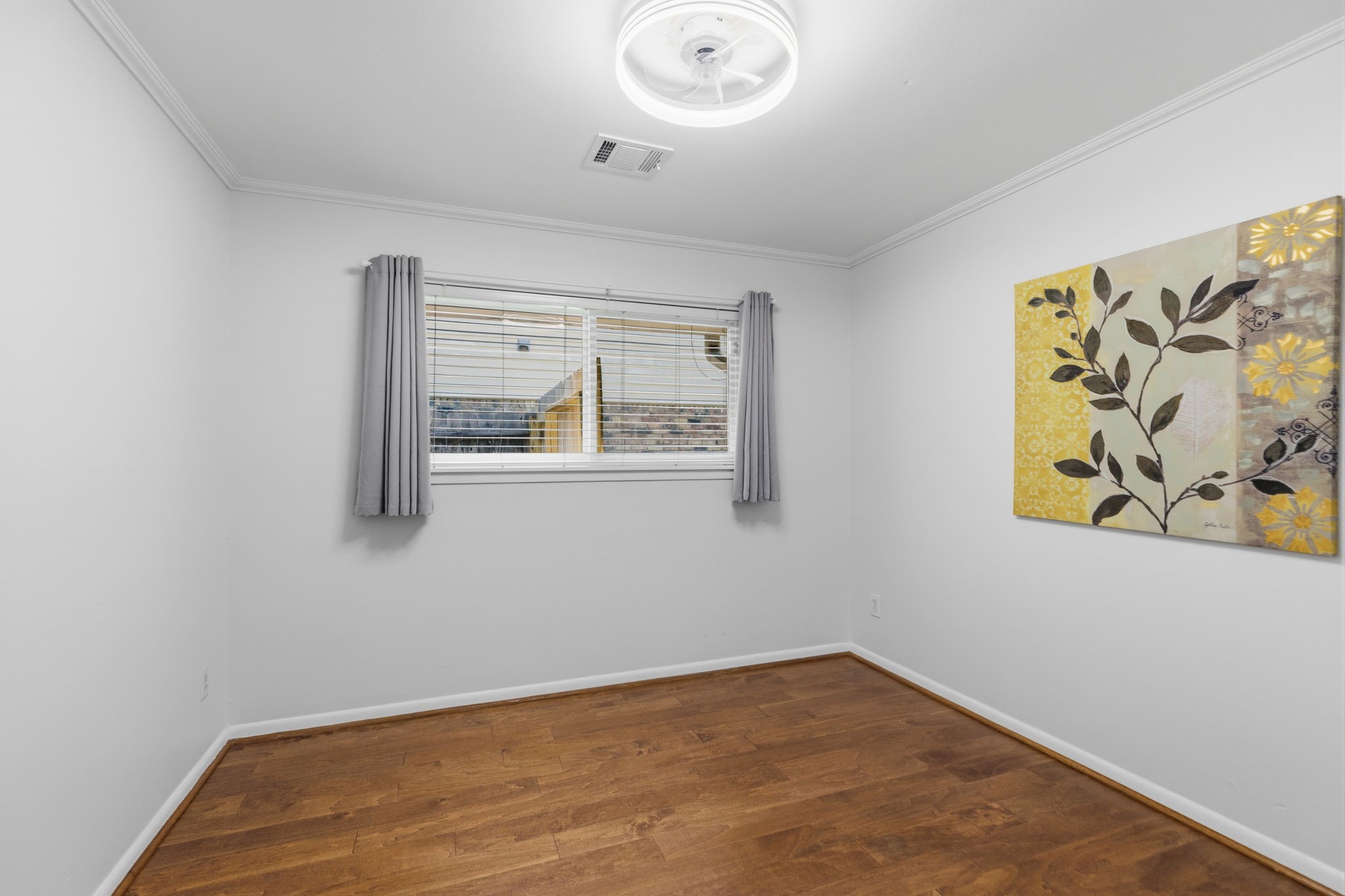 5410 Indigo Street Houston, TX 77096 - Photo 20 of 30 Large secondary bedroom has double pane windows, gleaming floor and fresh paint.