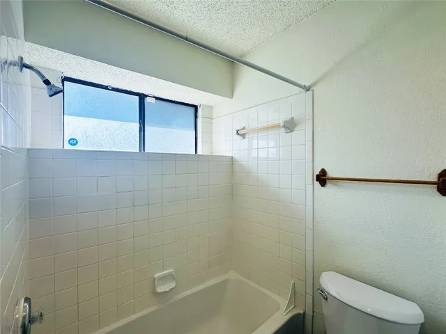 a bathroom with a shower and a toilet