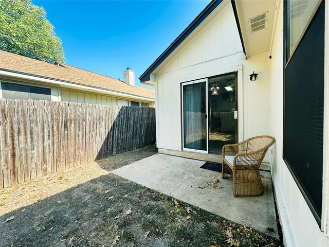 a balcony with table and chairs