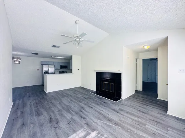 a view of a livingroom with a fireplace and wooden floor