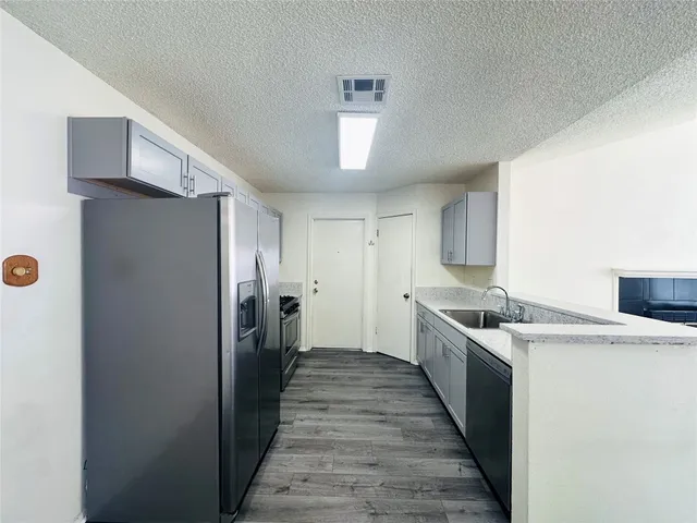 a kitchen with a stove a refrigerator and a sink