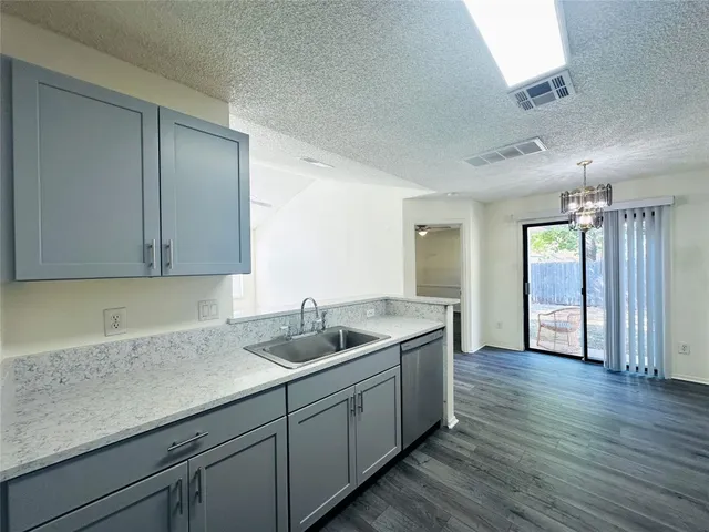 a kitchen with a sink and cabinets