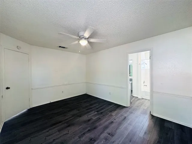 an empty room with wooden floor and window