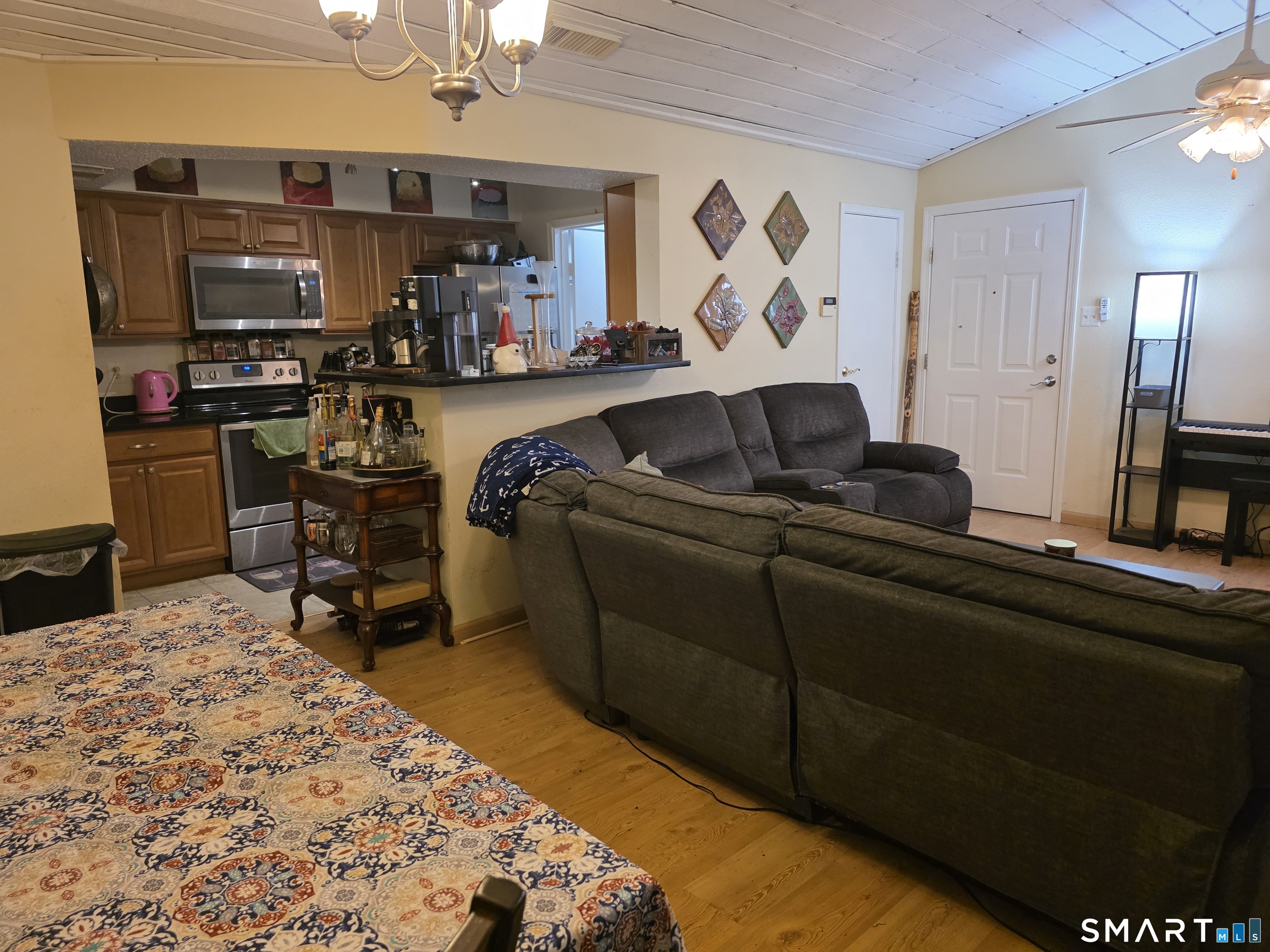 90 Crown Knoll Court, Unit 144 Groton, CT 06340 - Photo 11 of 38 a bed room with a bed furniture and a flat tv screen