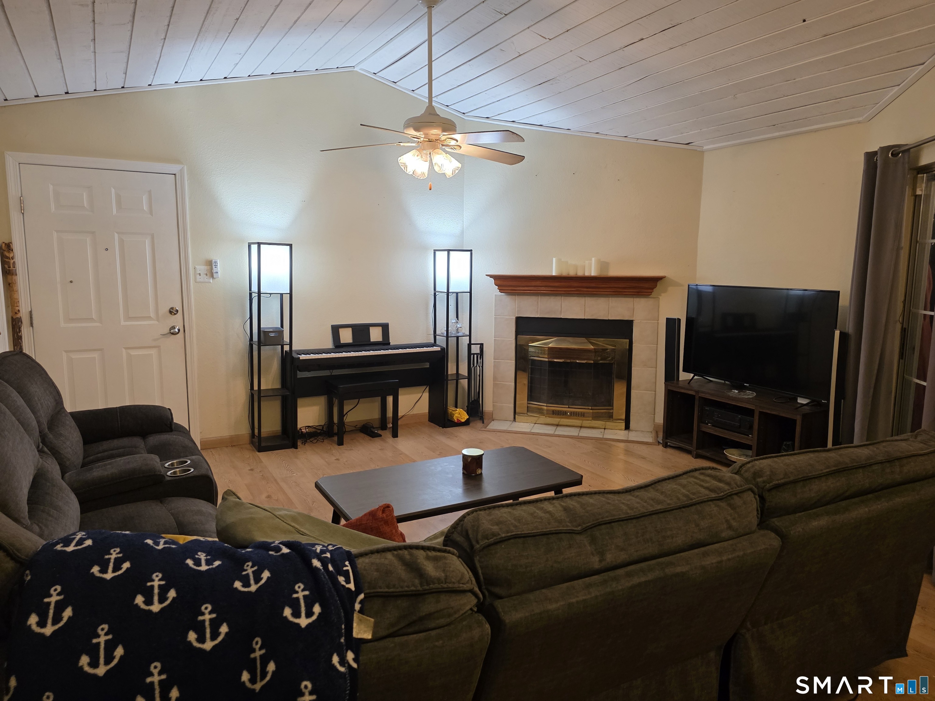 90 Crown Knoll Court, Unit 144 Groton, CT 06340 - Photo 13 of 38 a living room with furniture a flat screen tv and a fireplace
