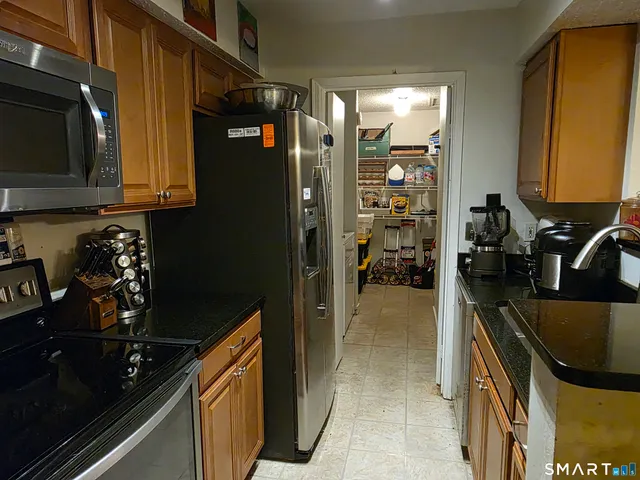 a kitchen with a refrigerator and a sink
