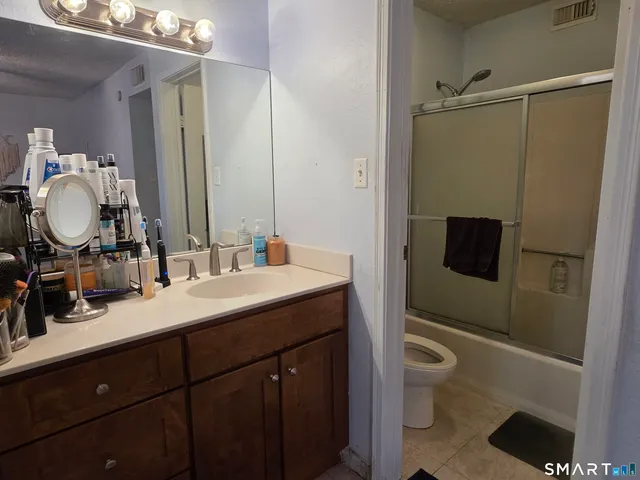 a bedroom with a bed and a desk