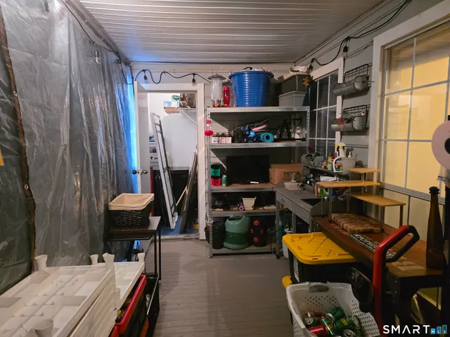 a room with furniture a flat screen tv and a window