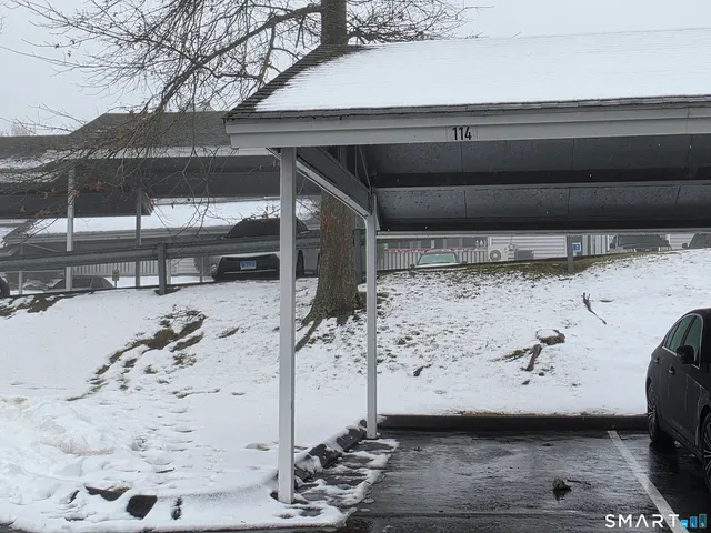 a view of a room with wooden floor and white walls