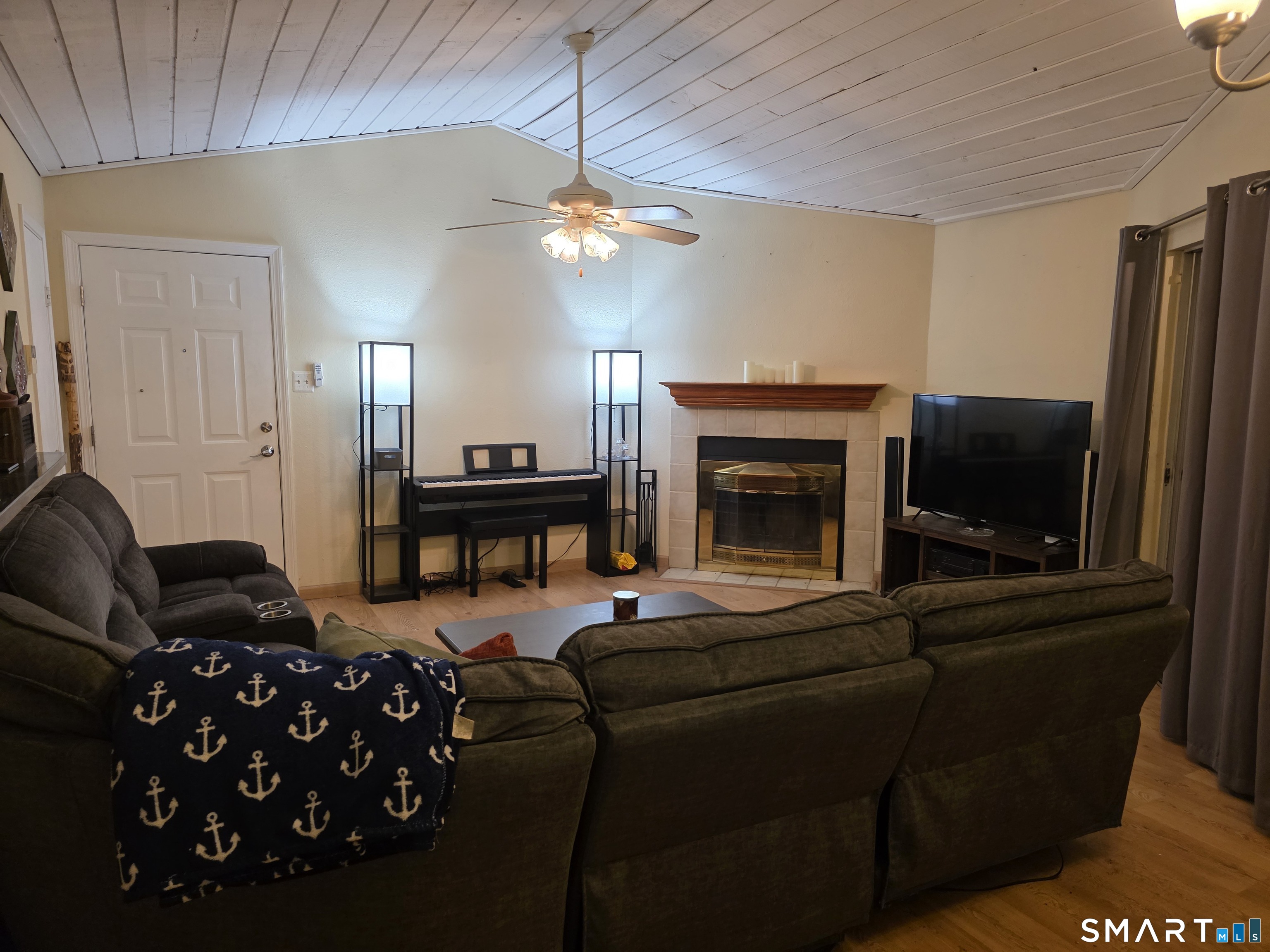 90 Crown Knoll Court, Unit 144 Groton, CT 06340 - Photo 9 of 38 a living room with furniture a flat screen tv and a fireplace