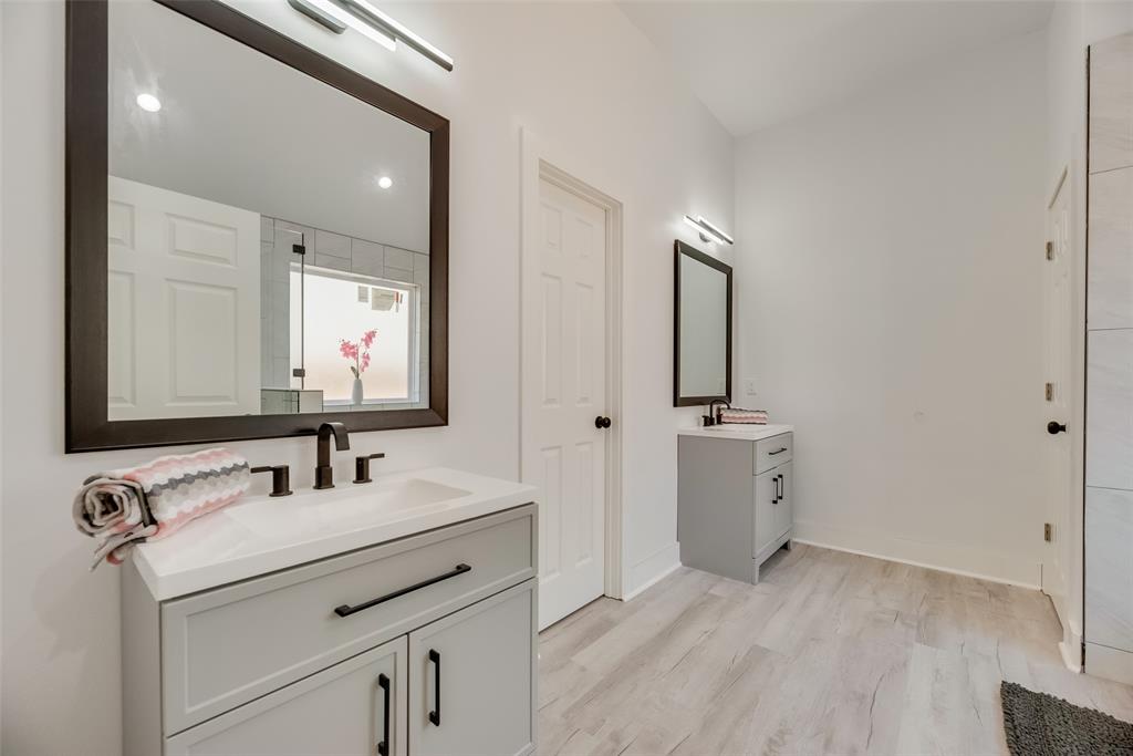 6031 Plum Dale Road Dallas, TX 75241 - Photo 15 of 23 a bathroom with a sink and a mirror