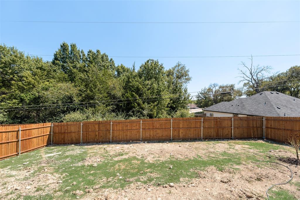 6031 Plum Dale Road Dallas, TX 75241 - Photo 17 of 23 a backyard of a house with lots of green space