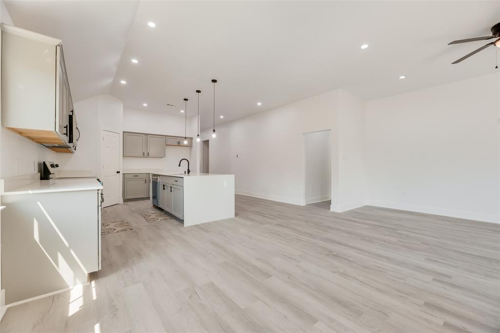 6031 Plum Dale Road Dallas, TX 75241 - Photo 5 of 23 a view of a kitchen with refrigerator and white cabinets