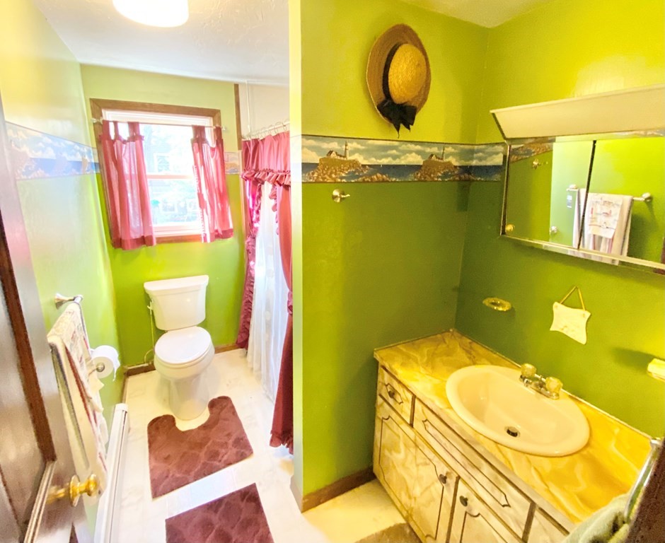 1 Pinewood Road Wareham, MA 02532 - Photo 16 of 16 a bathroom with a sink mirror vanity and toilet