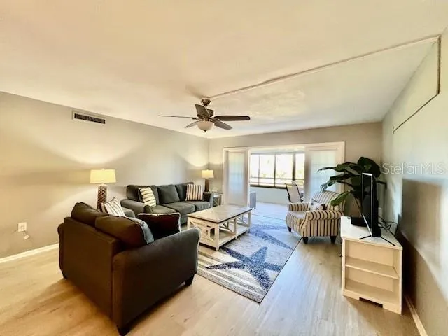 a living room with furniture and a wooden floor