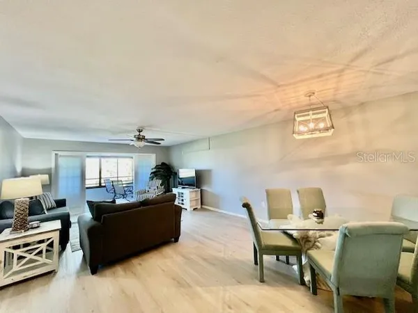 a view of a livingroom with furniture and a flat screen tv
