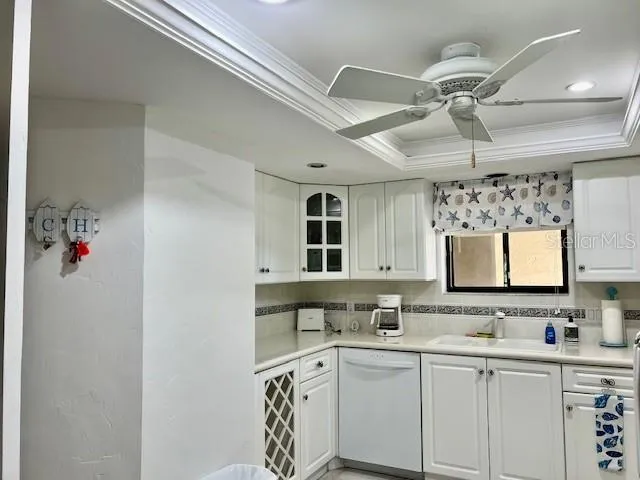 a kitchen with white cabinets and white appliances
