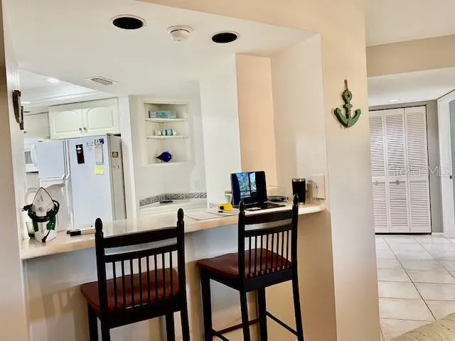 a kitchen with stainless steel appliances a refrigerator and a stove top oven