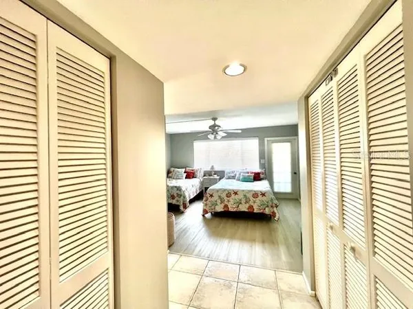 a bedroom with two beds and chandelier