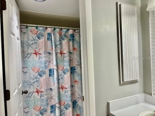 a bathroom with a double vanity sink a mirror and a bathtub