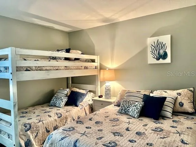 a bedroom with bed and cabinet