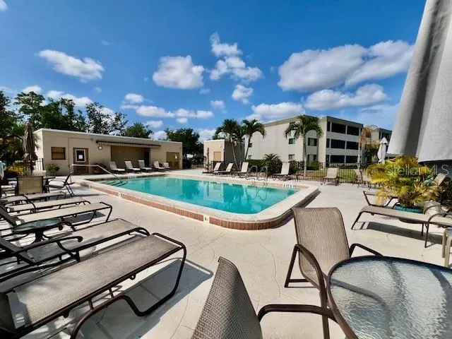 a view of a patio with swimming pool table and chairs