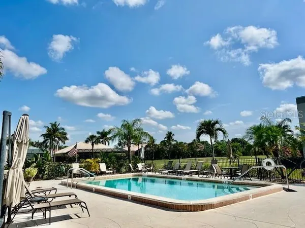 a view of a swimming pool with outdoor seating