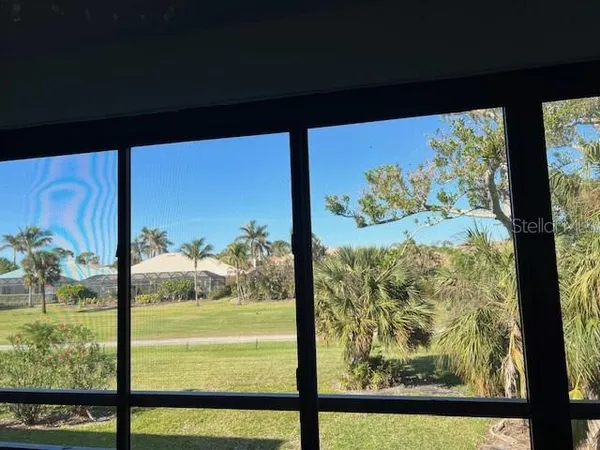 a view of a floor to ceiling window next to a yard