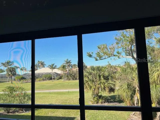 a view of a floor to ceiling window next to a yard