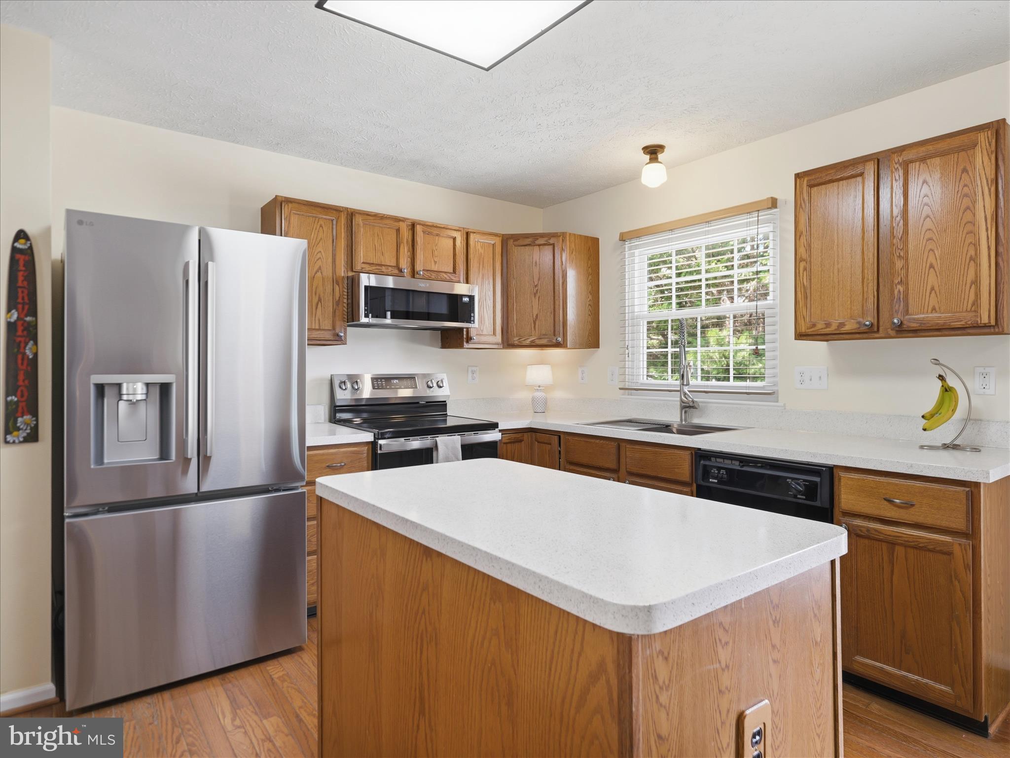 7 Coldstream Court Boonsboro, MD 21713 - Photo 12 of 43 a kitchen with a refrigerator a sink a stove a microwave and wooden cabinets