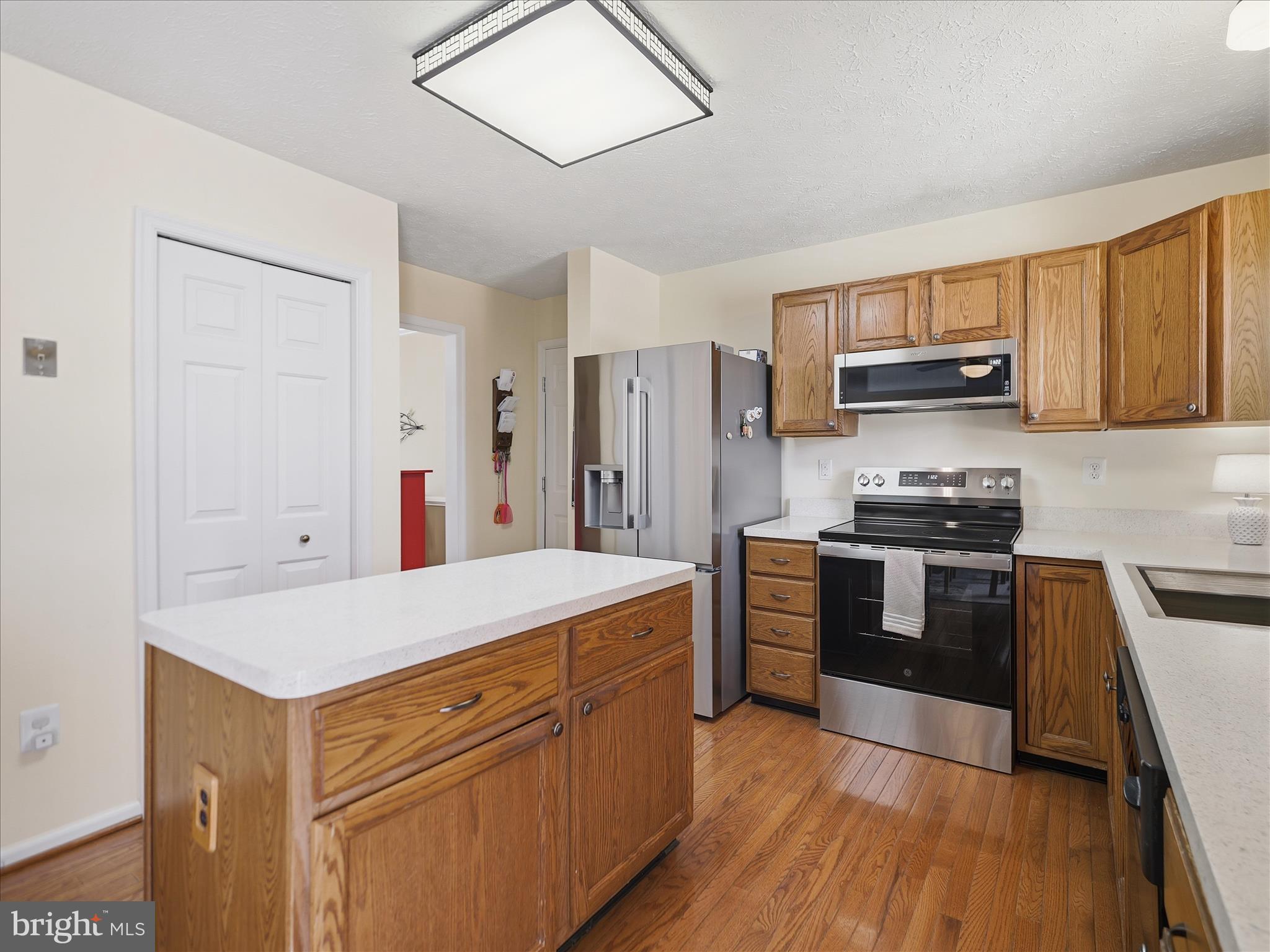 7 Coldstream Court Boonsboro, MD 21713 - Photo 16 of 43 a kitchen with stainless steel appliances granite countertop a stove refrigerator and a microwave oven