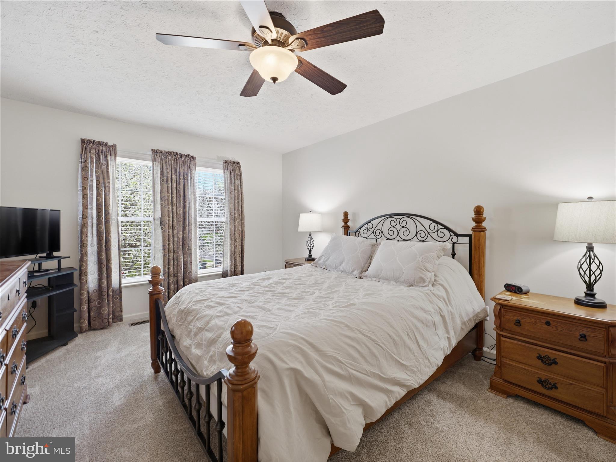 7 Coldstream Court Boonsboro, MD 21713 - Photo 22 of 43 a bedroom with a bed and a flat tv screen on dresser
