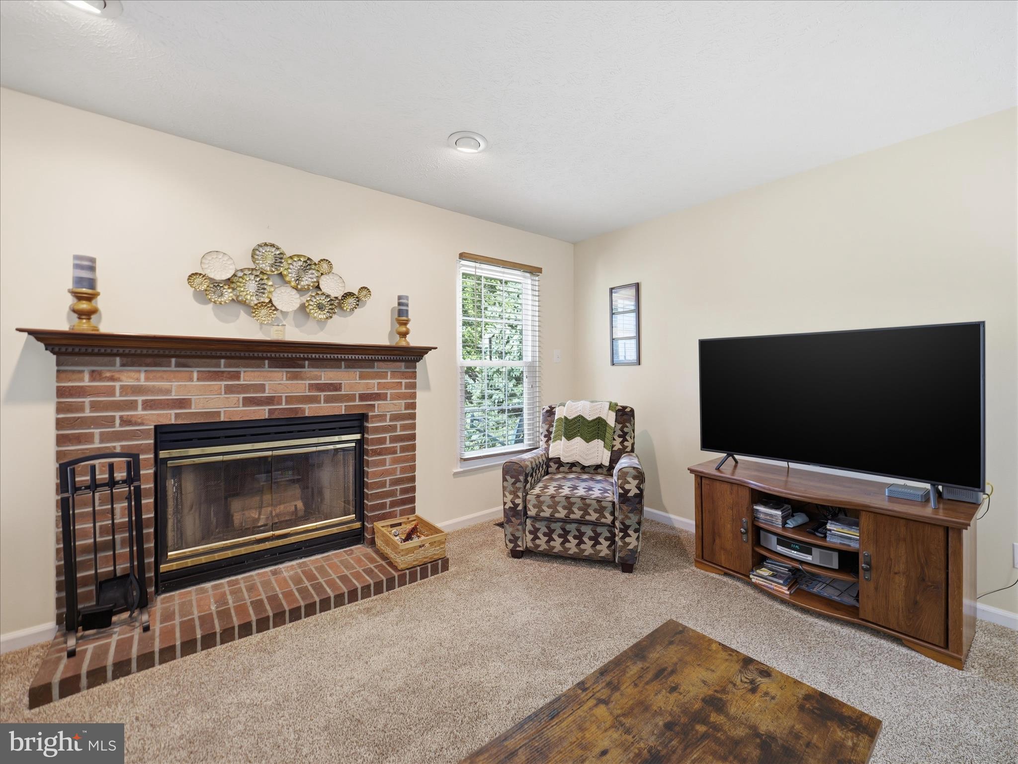 7 Coldstream Court Boonsboro, MD 21713 - Photo 8 of 43 a living room with furniture a flat screen tv and a fireplace