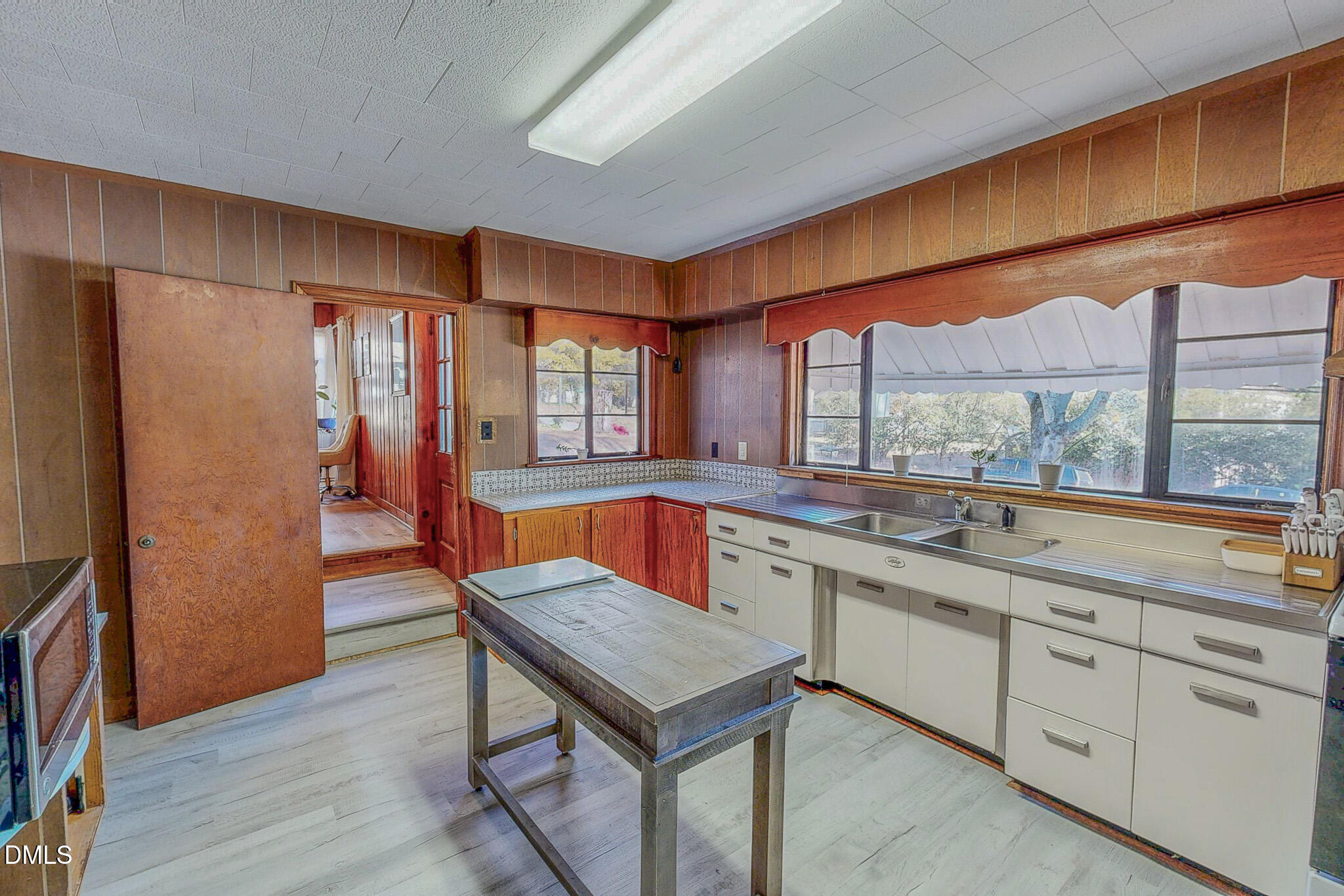 515 Reams Avenue Roxboro, NC 27573 - Photo 11 of 29 a kitchen with a sink a counter space and a refrigerator