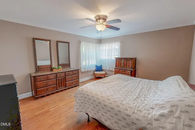 a bedroom with a bed and a dresser in it