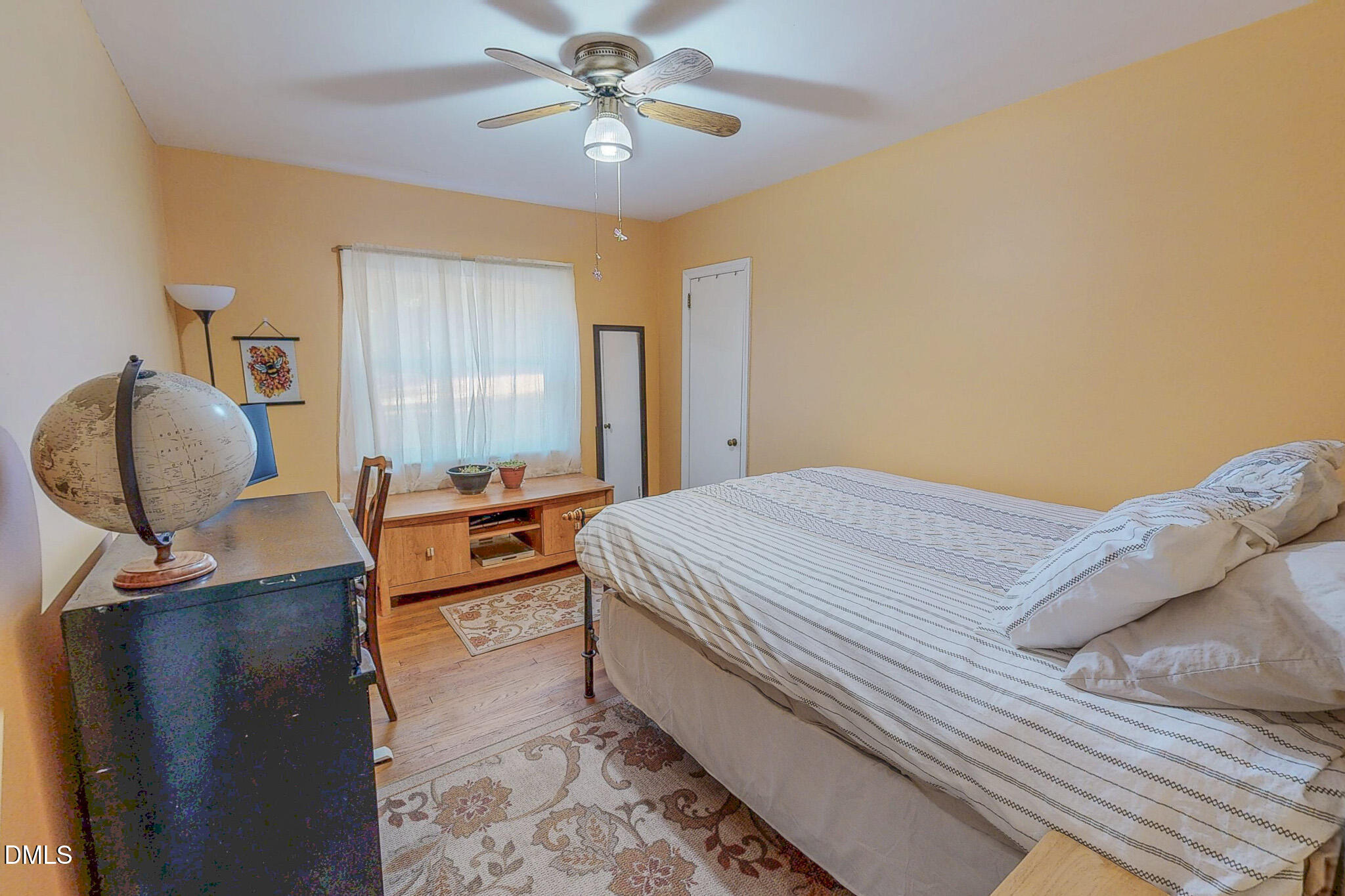 515 Reams Avenue Roxboro, NC 27573 - Photo 19 of 29 a bedroom with a bed and a chandelier