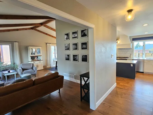 a living room with furniture and kitchen view