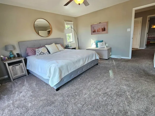 a bedroom with a large bed and a large window