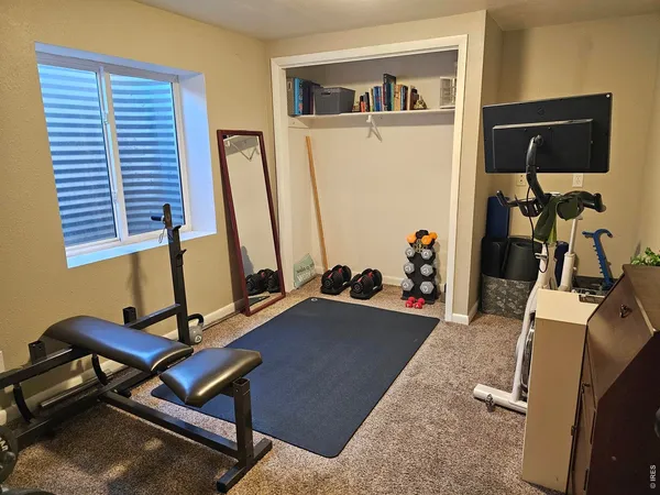 a bedroom with a bed and a desk