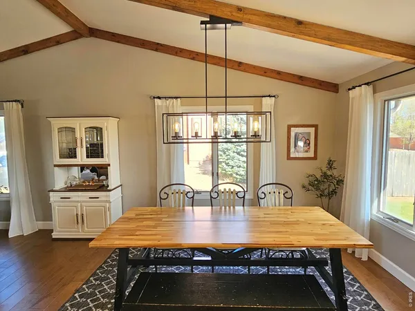 a large kitchen with sink a refrigerator and glass windows