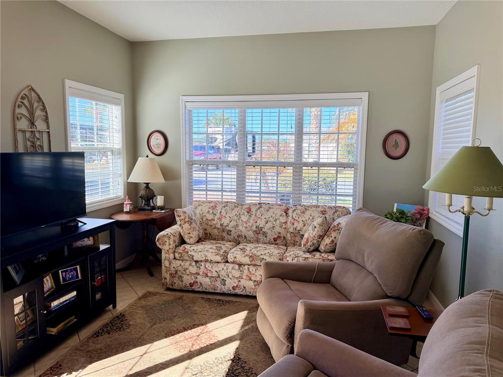 4805 Southeast 94th Avenue Webster, FL 33597 - Photo 11 of 35 a living room with furniture and a flat screen tv